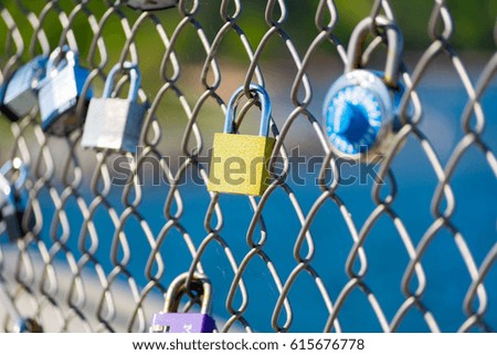 Locks locked on a gate to represent love and unbreakable friendships.