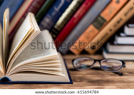 Many old books on wooden background. The source of information. Knowledge is power
 Royalty-Free Stock Photo #615694784