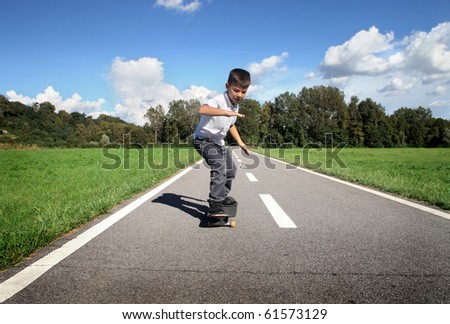 Child using a skateboard on a road