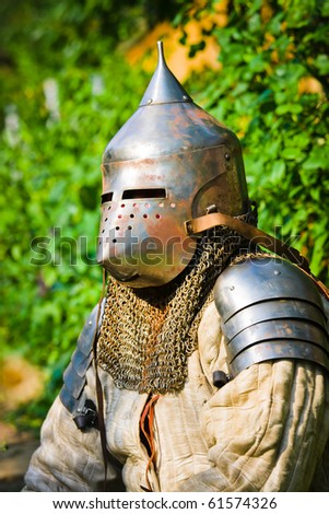 man in knight's helmet on a green background