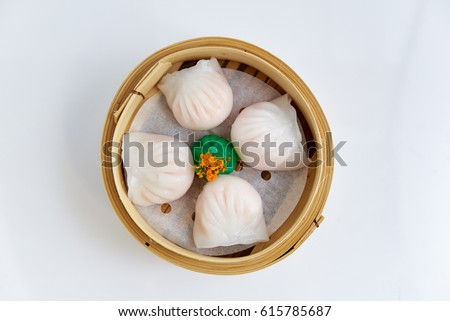 Overhead view of tradition Chinese prawn dumplings placed in a bamboo steamer Royalty-Free Stock Photo #615785687