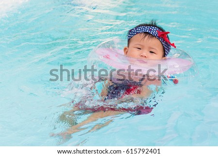 Asian cute eight month baby relax swimming pool, Active healthy first time playing swim in pool at home.