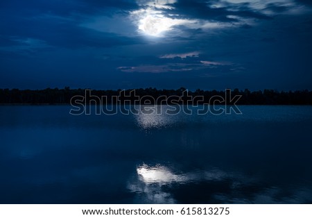 Fantastic view in the evening after sunset. Romantic scenic of full moon with reflection in sea. Beautiful nature background, outdoors at nighttime