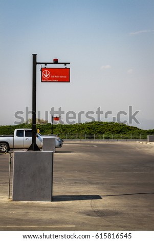 metal sign with orange flashing light. Led at outdoor car parking.