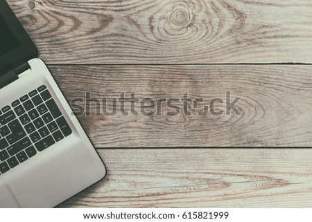 Laptop computer on wooden background