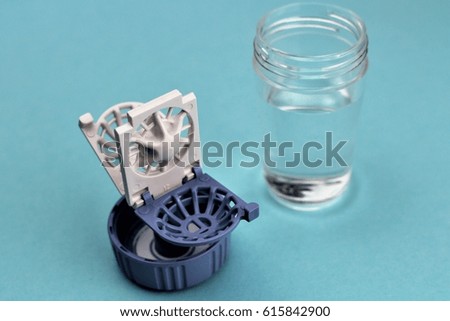An Image of a contact lens case - Background blurry