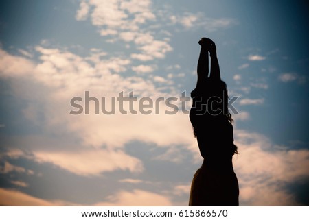 Silhouette woman happy at sunset sky outdoor