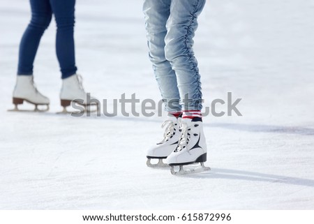 feet skating on the ice rink