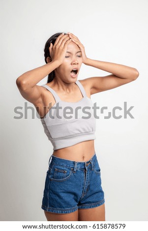 Stressed young Asian businesswoman scream out on white background