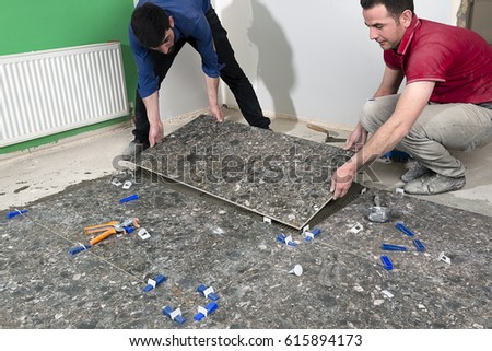 Construction Workers Installing Tiles   