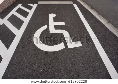 Wheelchair sign in the parking lot.