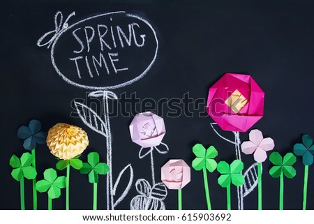 Blackboard background with painted with chalk and origami flowers