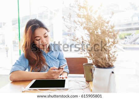 Asian woman using telephone in coffee shop, Relaxation concept