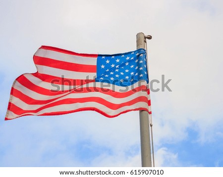 United States of America flag with cloudy blue sky