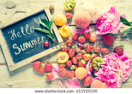 Summer fruits and berries on a wooden background/toned photo