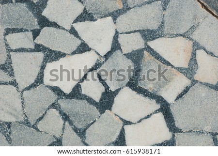 Grey mosaic texture from stones. Marble background. Exterior decoration.