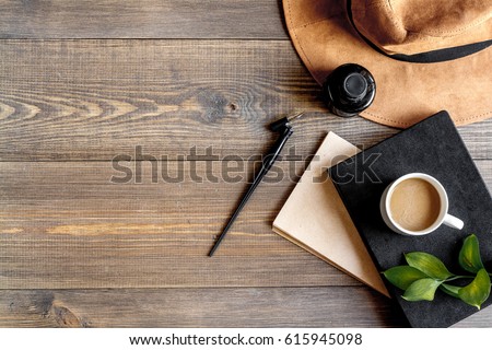 writer workplace with tools on wooden background top view mockup