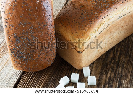 homemade bread with poppy seeds on a wooden background