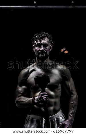 training cross fit in the gym,muscular man is at the gym,the concept of sport
