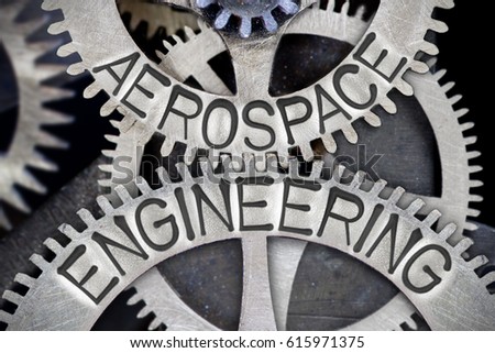 Macro photo of tooth wheel mechanism with AEROSPACE ENGINEERING concept letters