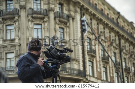 professional Videographer shoots the city against historical building in Moscow city. 