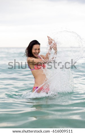 girl laugh while splashing the water