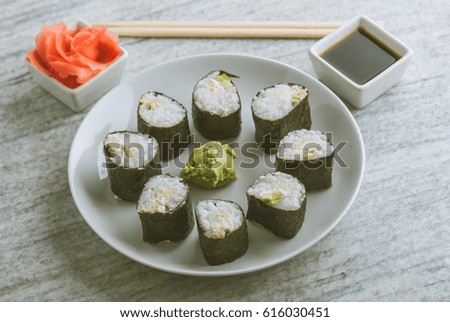 Set up of vegetarian sushi rolls of avocado and cucumber with ginger, wasabi and soy sauce