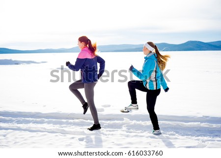 Two girls jogging in winter