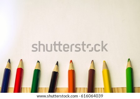 sheet of paper with colored pencils/the sheet of paper with pencils