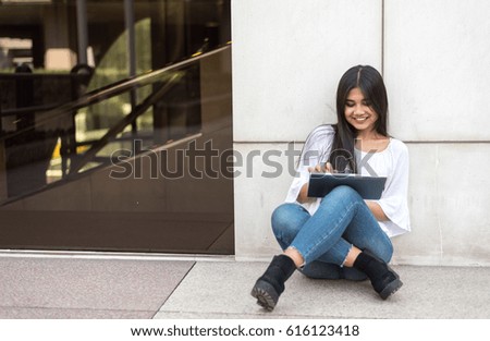 happy young woman student portrait close up smiling with tablet