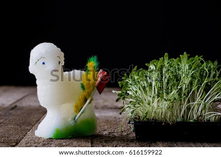 Easter lamb, cress and palm tree on an old wooden table