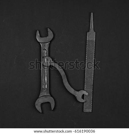 Letter N. Alphabet made of repair tools. Creative black and white font