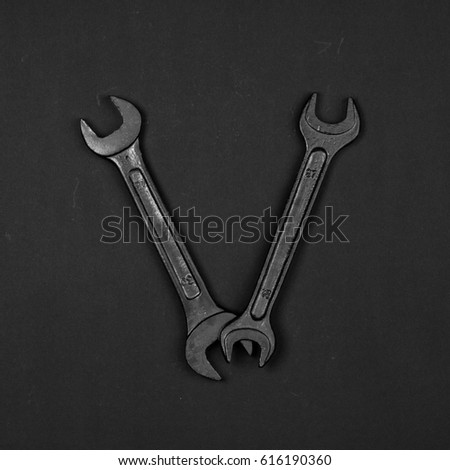 Letter V. Alphabet made of repair tools. Creative black and white font