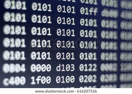 Binary file code close up. Abstract information technology background. Modern technologies screen concept. Macro shot of display with shallow field of depth.