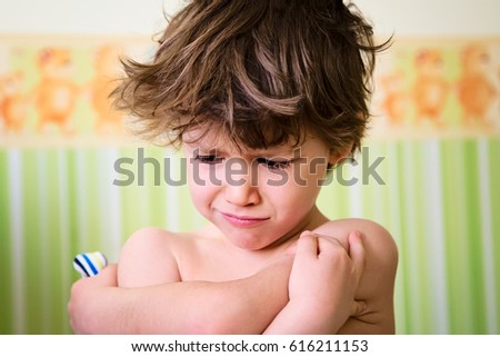 Portrait of little kid with angry upset face expression. Cute child making a sad face Royalty-Free Stock Photo #616211153