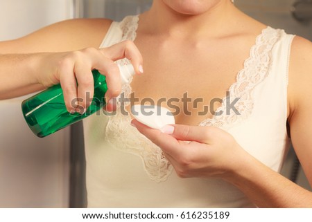Make up remove skin care. Closeup woman holding cotton swab and makeup remover liquid cosmetic in hands. Royalty-Free Stock Photo #616235189