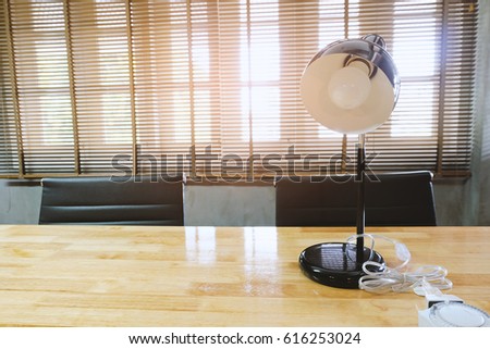 Electic lamp on working  table with chair ,window office with light.