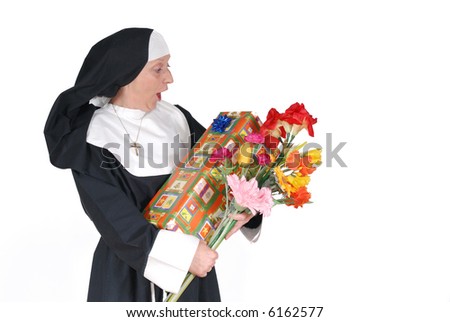 Middle aged  sister, nun with birthday present and flowers, happy, surprised expression on face