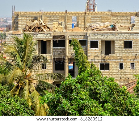 Construction site. Nice photo of unfinished building on a town background. Contemporary urban landscape. Developing of modern civil engineering. Construction industry