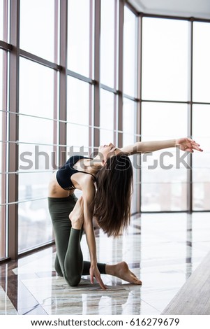 Young woman meditates while practicing yoga. Freedom concept. Calmness and relax, woman happiness. Toned picture
