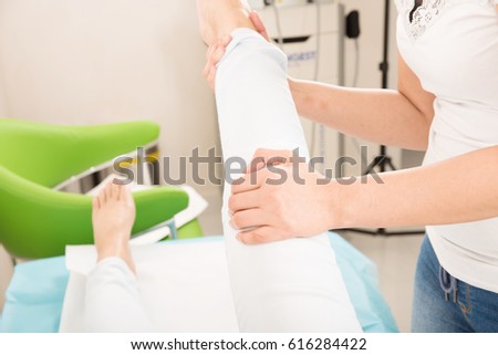 Physiotherapist doing a patellar mobilization, Knee Joint