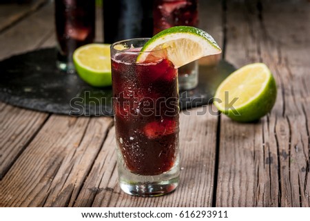 Traditional Spanish alcoholic drink, cocktail, Calimocho. With wine, cola, lime juice and ice. Decorated with pieces of lime. Copy space