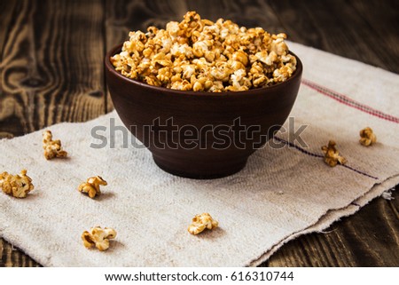 caramel popcorn in the bowl wooden background Royalty-Free Stock Photo #616310744