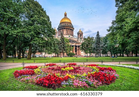 St. Isaac's Cathedral in St. Petersburg on a summer evening and brightly-colored flowers in a flowerbed Royalty-Free Stock Photo #616330379