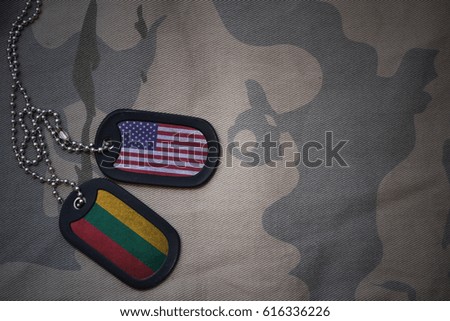 army blank, dog tag with flag of united states of america and lithuania on the khaki texture background. military concept