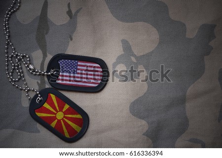 army blank, dog tag with flag of united states of america and macedonia on the khaki texture background. military concept