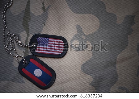 army blank, dog tag with flag of united states of america and laos on the khaki texture background. military concept