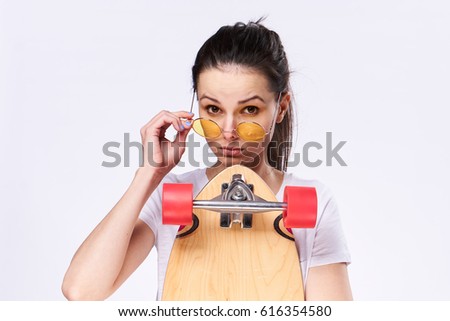 Girl in glasses with skate in hands in glasess