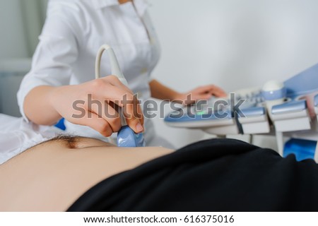 Ultrasound examination. Doctor keep holding in her hand an ultrasound transducer. Close up.
USG machine 