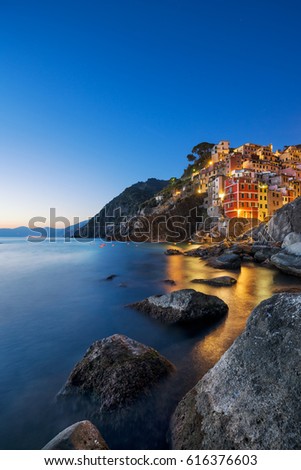 Riomaggiore town, cape and sea landscape at sunset. Seascape in Cinque Terre National Park, Liguria Italy Europe. Long Exposure